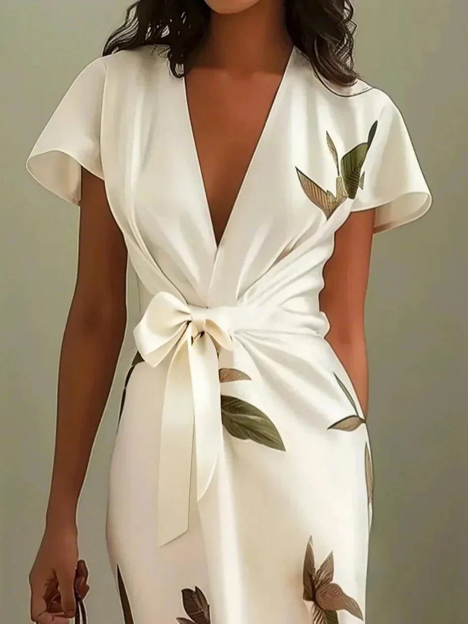 Women's botanical leaf print wrap maxi dress showing cinched waist and flowing skirt, side view