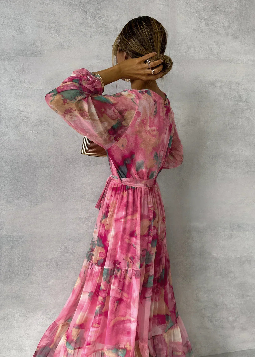 Women's floral maxi dress with belt and pleated skirt, three-quarter view
