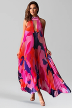 Women's printed halter neck maxi dress with floaty pleated skirt, back view