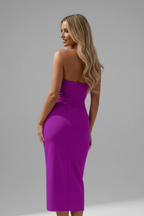 Close-up of ruched waist detail on women's strapless midi dress
