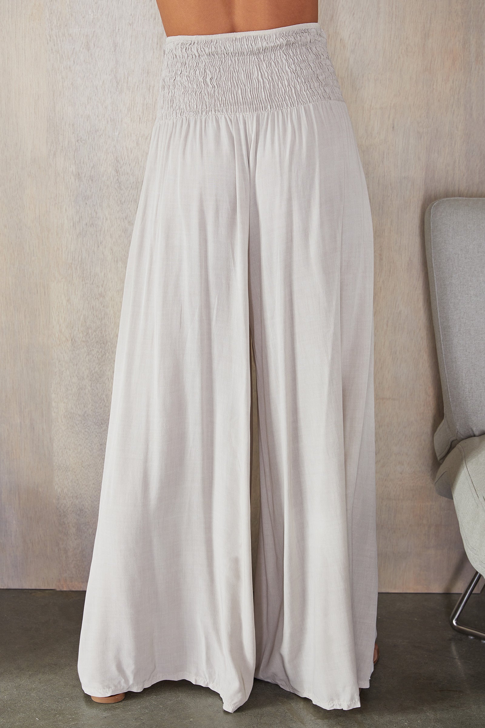 Women's wide leg trousers, close up of smocked waistband detail