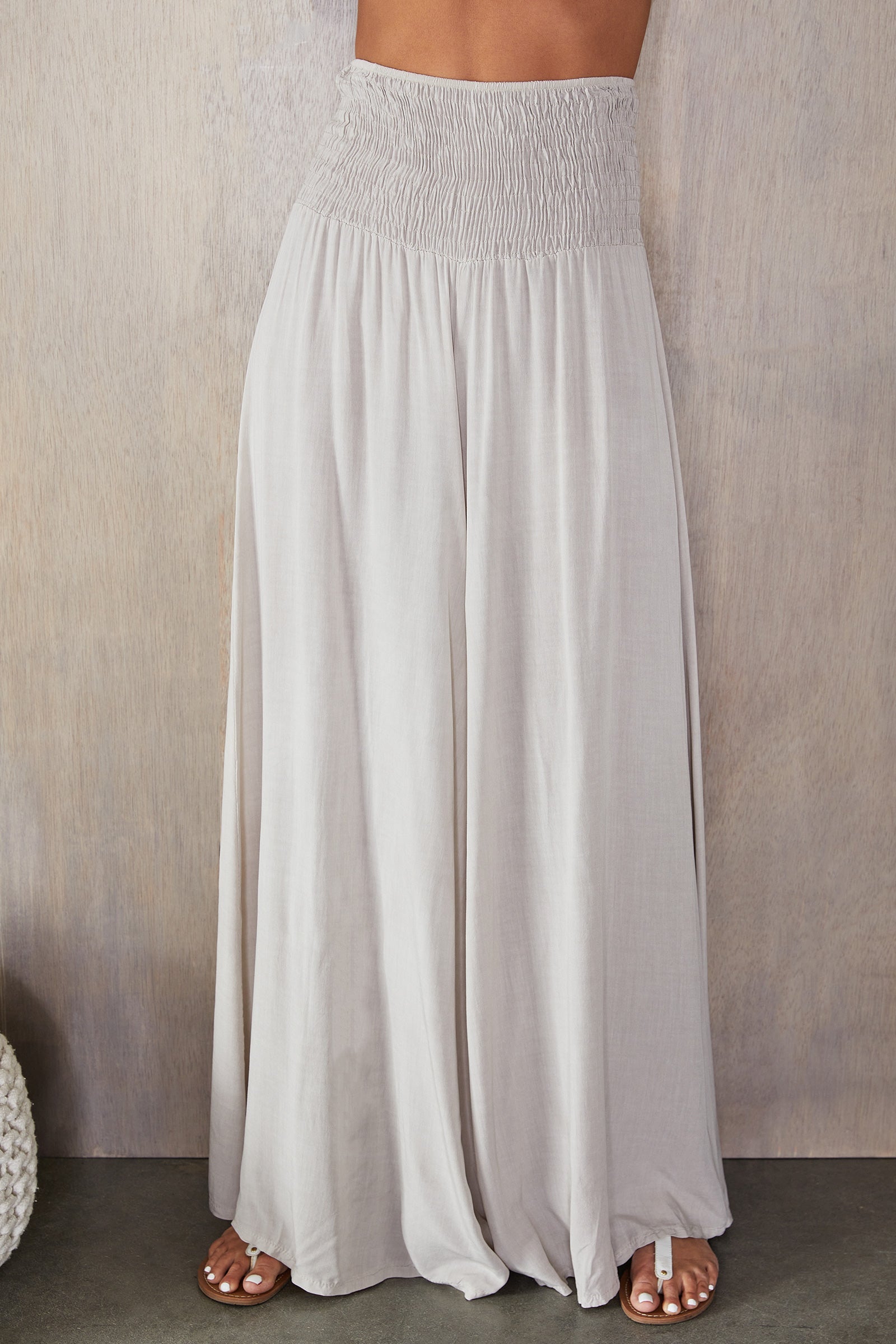 Women's wide leg smocked waist trousers, front view