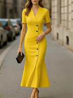 Women's vibrant yellow midi dress with structured collar and belted waist, side view