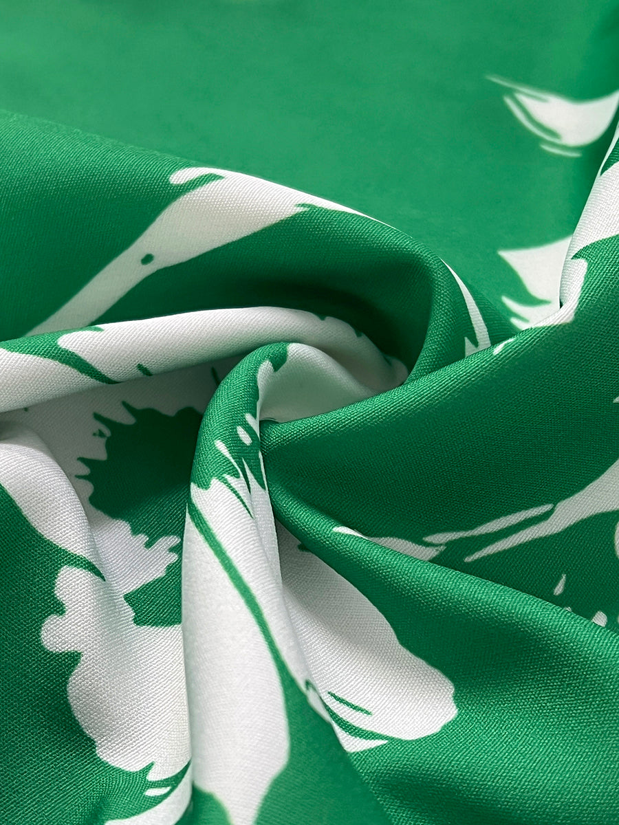 Close-up of green and white floral print fabric texture