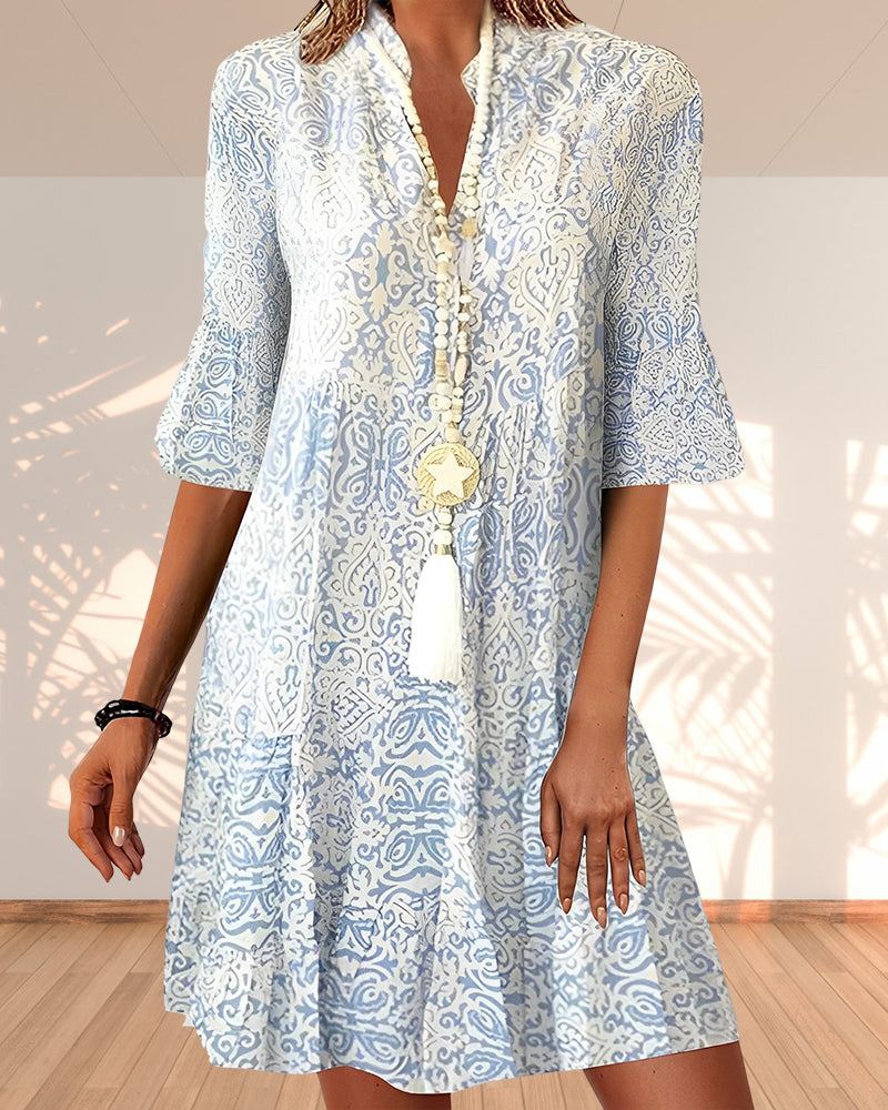 Women's blue floral V-neck bell sleeve boho dress in light blue and white print, front view
