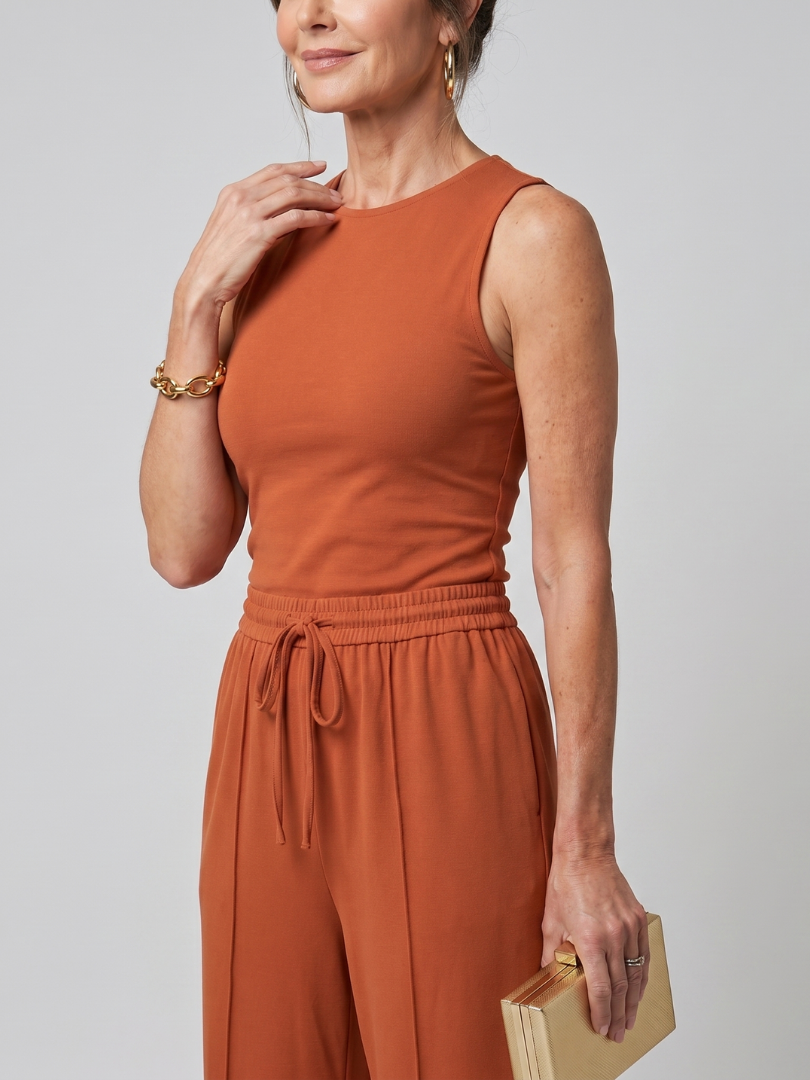 High neck top with flowing wide leg trousers, three-quarter view