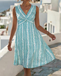 V-neck sleeveless criss cross knot print knee length dress in blue, front view