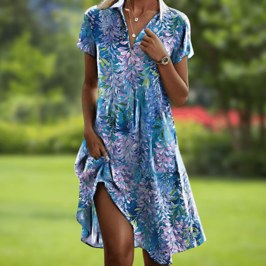 Floral midi dress with pockets showing flowing silhouette, side view