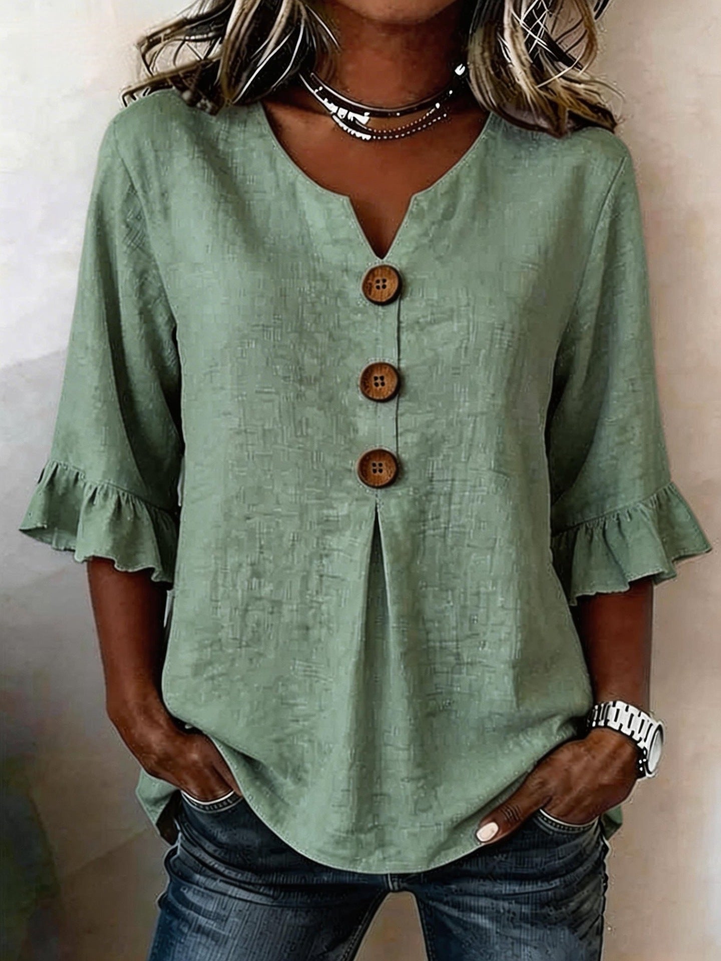 Women's ruffle button blouse in olive green, styled on model