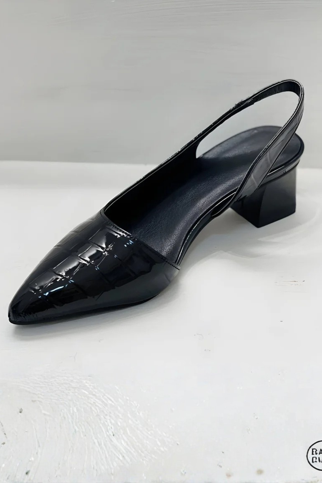 Women's low block heel pointed toe pumps with textured upper, three-quarter view