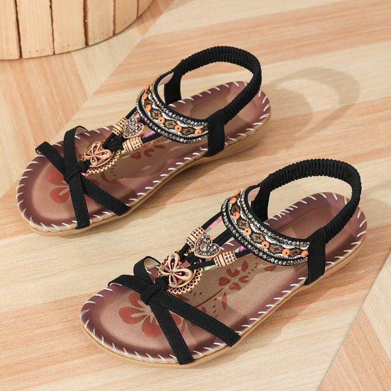 Women's flat sandals with golden pearl and elastic strap, back view