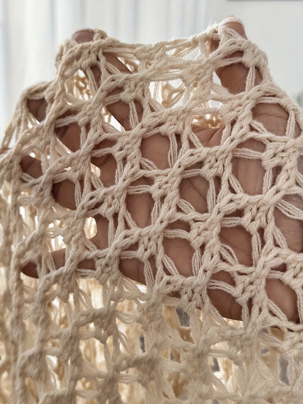 Women's crochet knit cardigan in beige, outdoor styled