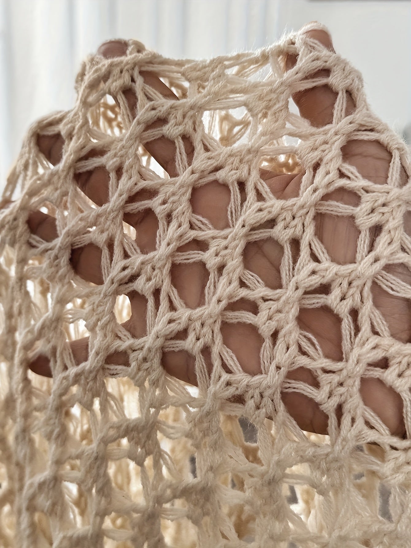 Women's crochet knit cardigan in beige, outdoor styled