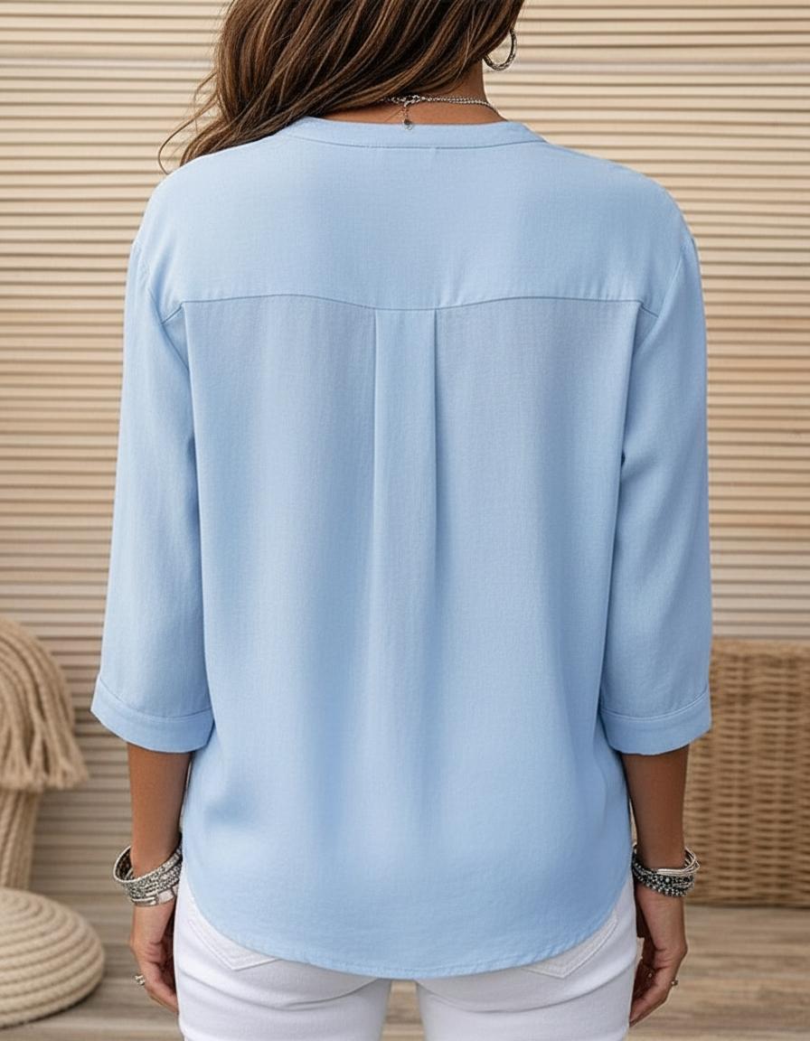 Women's light blue button-front blouse back view