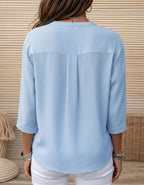 Women's light blue button-front blouse back view