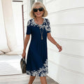 Women's navy floral print short sleeve A-line midi dress, front view