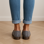 Grey suede loafers with minimal strap detail and low heel, front view