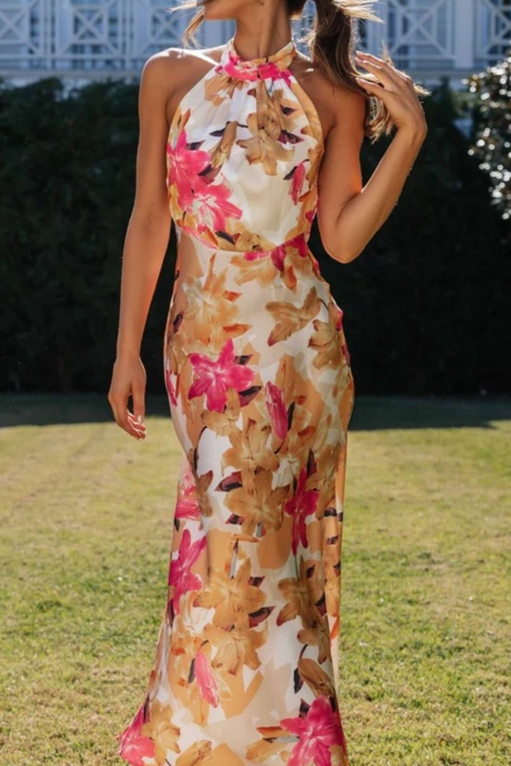 Women's floral print halter neck maxi dress with slit, side profile view
