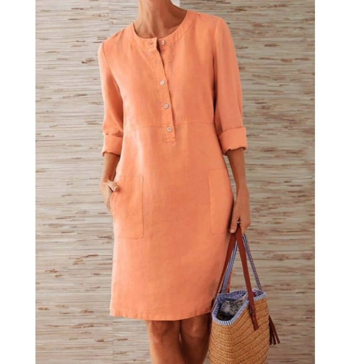 Women's knee-length cotton linen shift dress with front patch pockets, side view