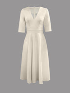 Women's wedding guest flared midi dress styled with heels