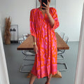 Hot pink and orange print shirred button front midi dress, front view on model