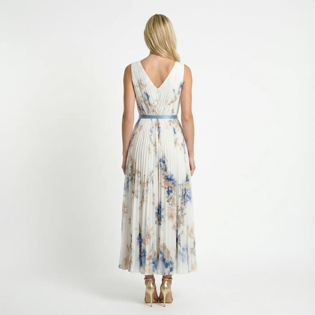 Floral pleated maxi dress in white – back view with belted waist