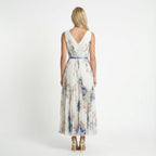 Floral pleated maxi dress in white – back view with belted waist