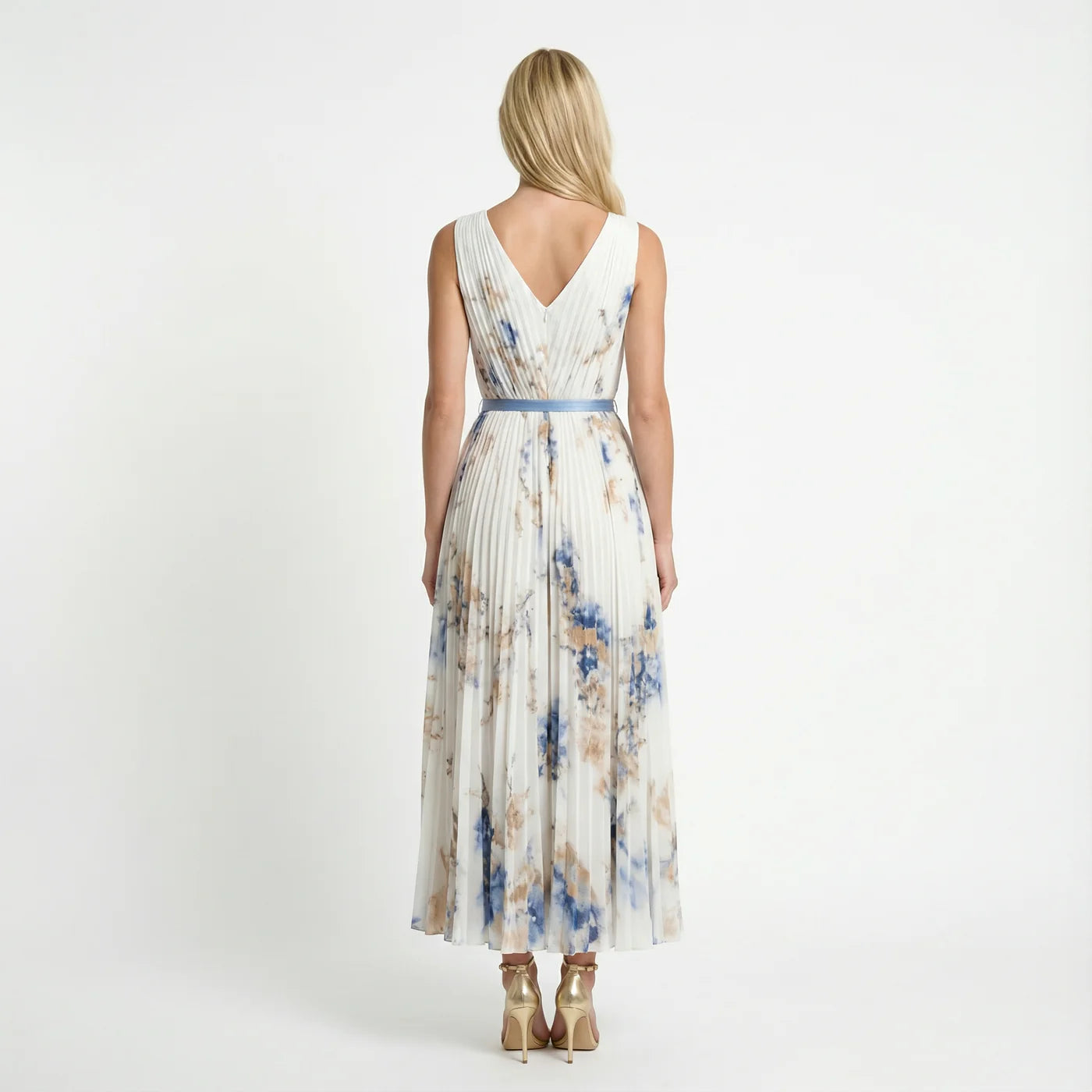 Floral pleated maxi dress in white – back view with belted waist