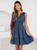 Women's denim mini dress with elastic waist and A-line silhouette, side view
