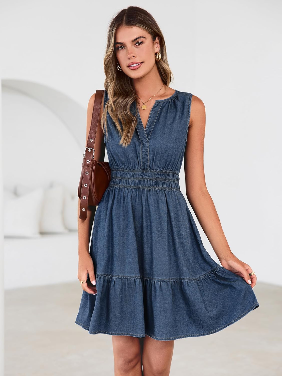Women's denim mini dress with elastic waist and A-line silhouette, side view