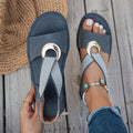 Flat slingback sandals with metal ring in blue, side view