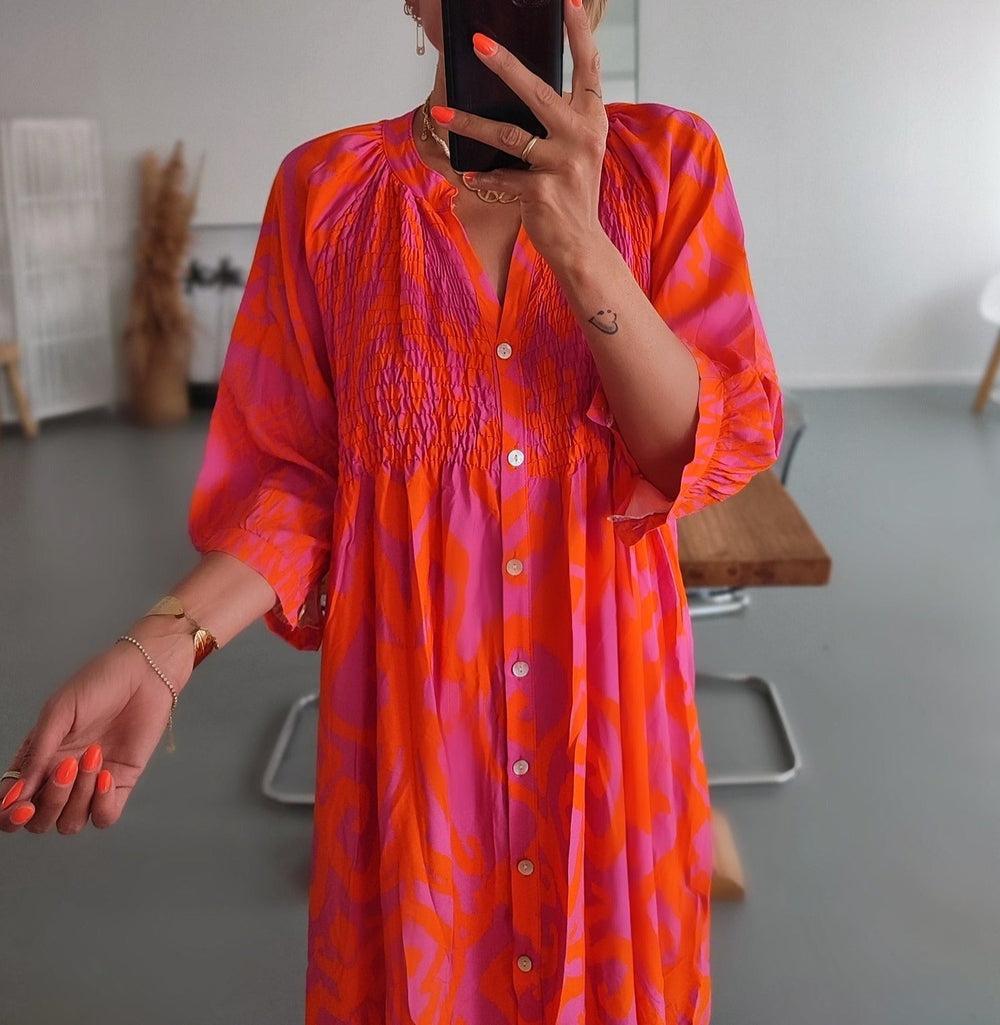 Bold pink print button front midi dress on model, lifestyle shot