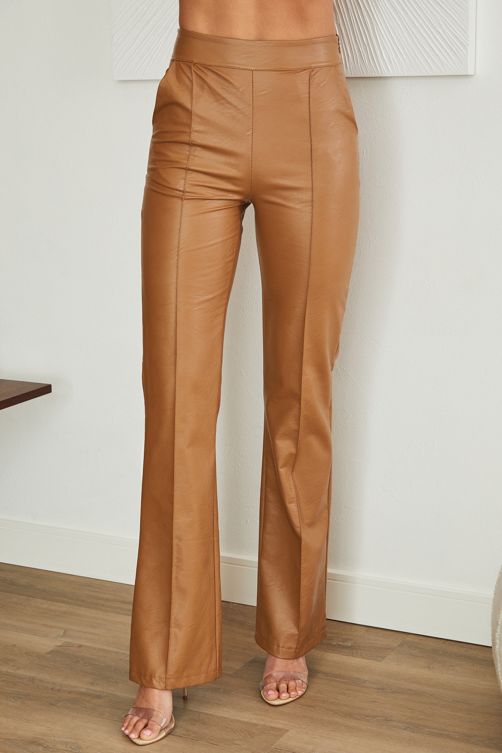 Women's faux leather trousers, model wearing outfit