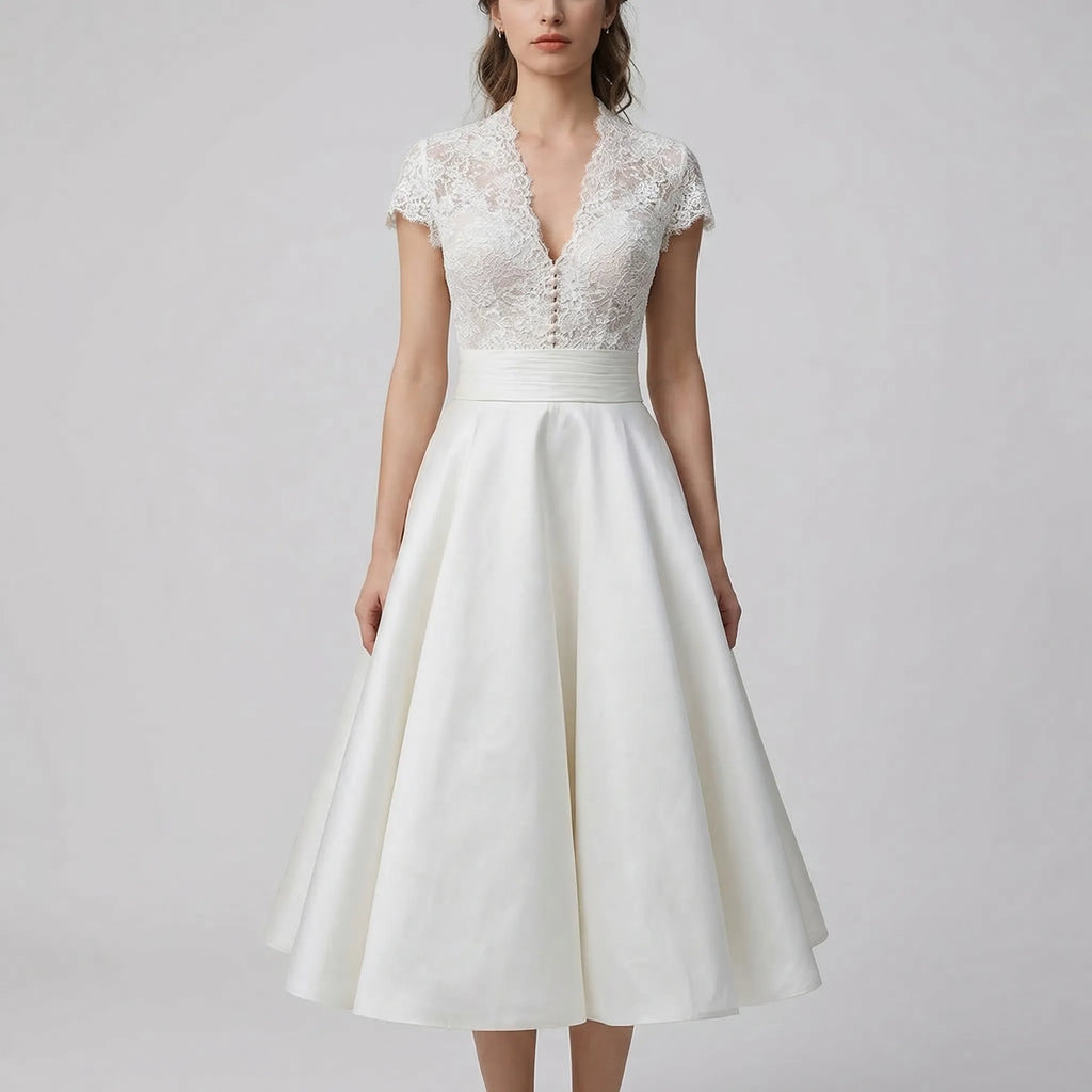 Women's lace bodice wedding dress detail showing scalloped V-neckline and A-line skirt