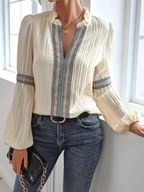 Women's embroidered blouse showing delicate vintage-inspired embroidery detail, close-up