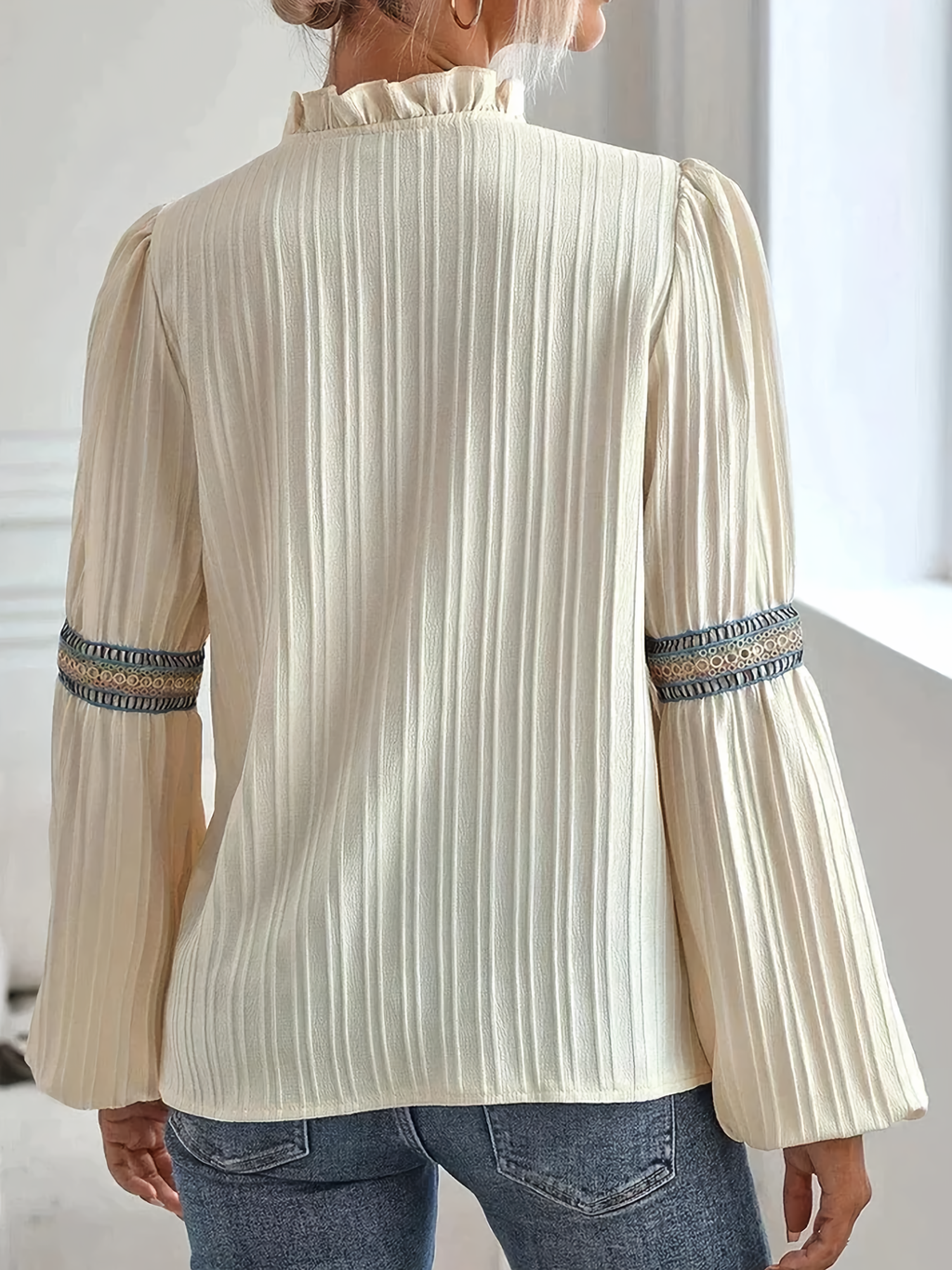 Women's light breathable embroidered blouse with graceful lines, side view