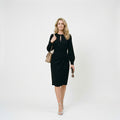 Long sleeve midi wedding guest dress styled for formal events