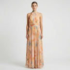 Women's floral halter neck maxi dress with open back, side profile view