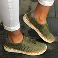Women's perforated slip-on shoes in green – vegan leather tassel detail side view