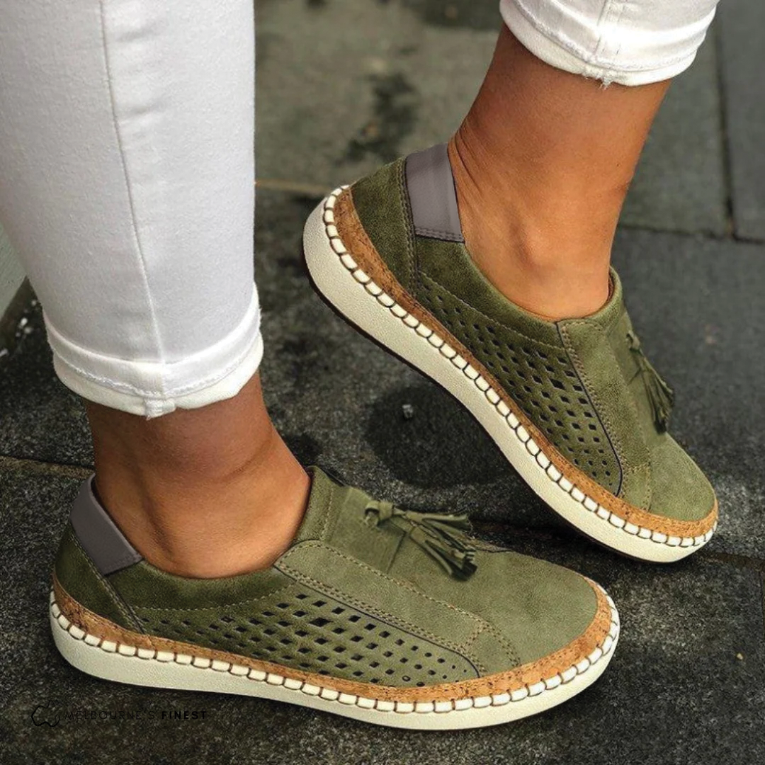Women's perforated slip-on shoes in green – vegan leather tassel detail side view