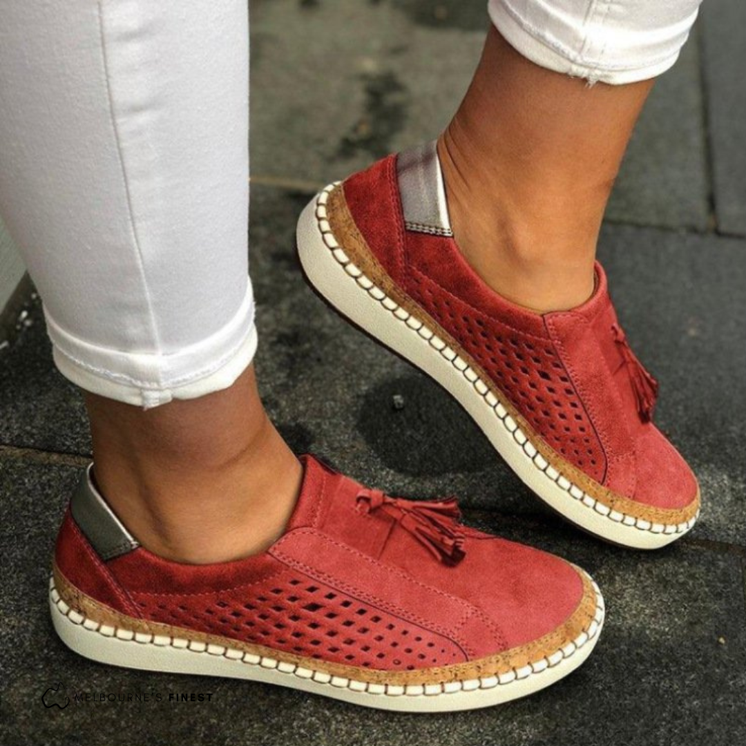 Women's perforated slip-on flat shoes in red – tassel detail side view