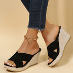 Women's cross strap wedge sandals styled with summer dress, lifestyle shot