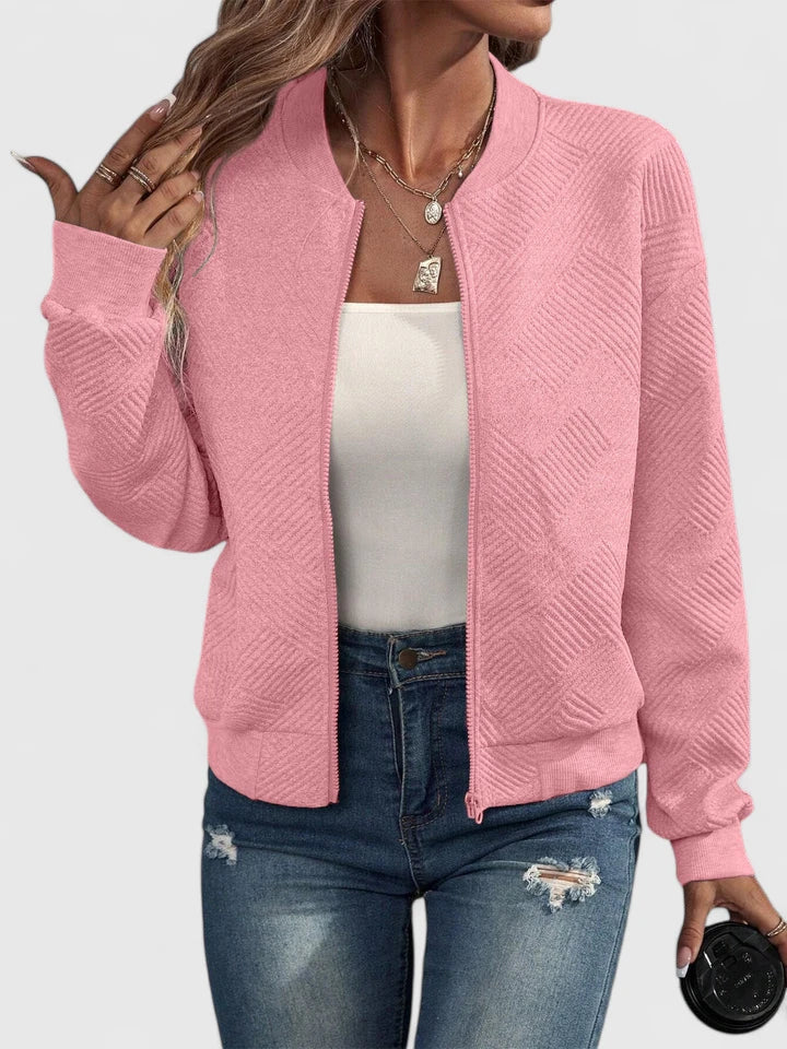 Pink textured geometric bomber jacket with ribbed collar, front view worn open