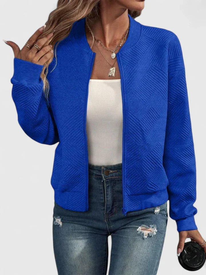 Blue textured geometric bomber jacket with ribbed collar, front view worn open