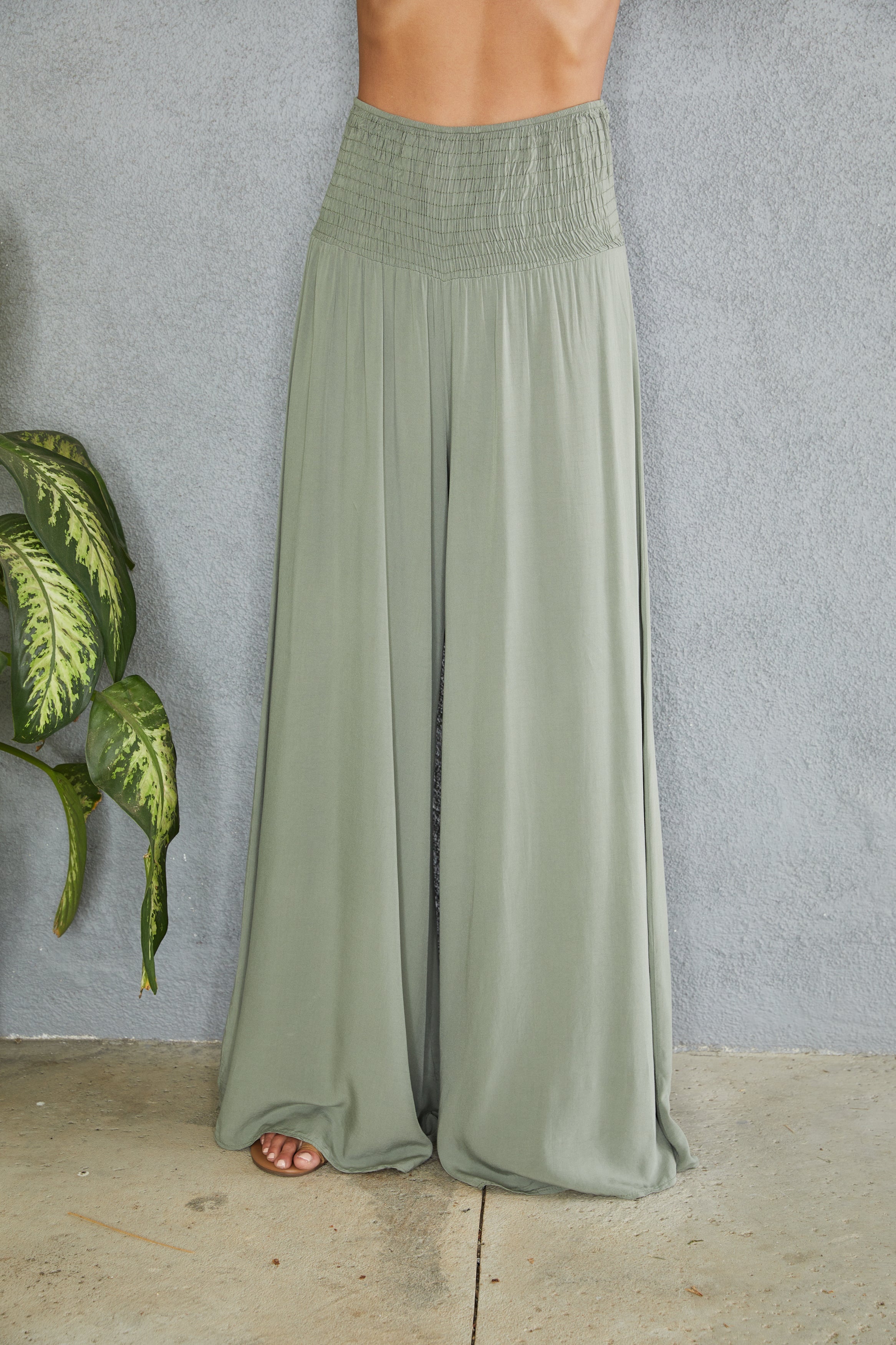 Women's wide leg smocked waist trousers, full length view