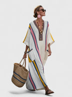 Women's striped kaftan maxi dress showing three-quarter sleeve with ribbed cuff detail