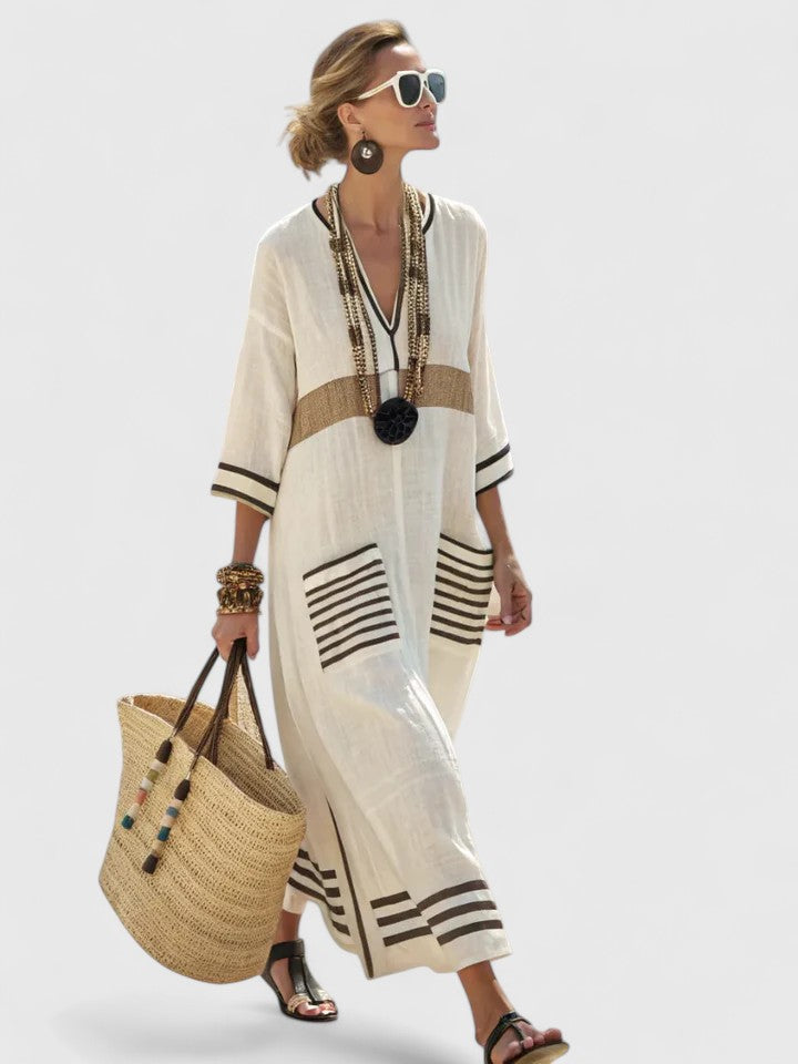 Women's kaftan maxi dress showing V-neckline and vertical stripe pattern, side view
