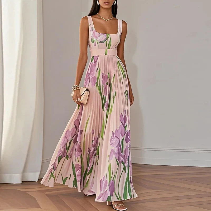 Women's floral pleated maxi dress in pink colourway, showing fitted bodice and A-line skirt