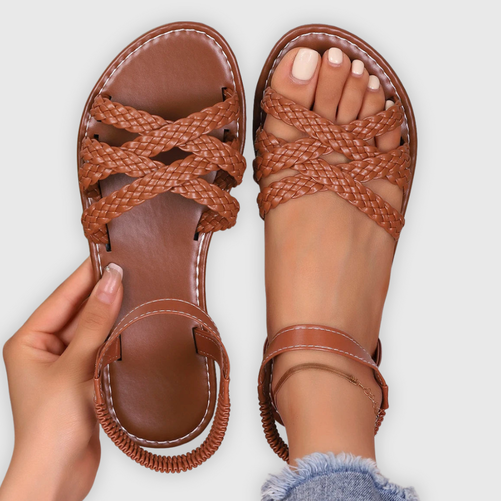 Women's vegan flat sandals with criss-cross strap design, side view
