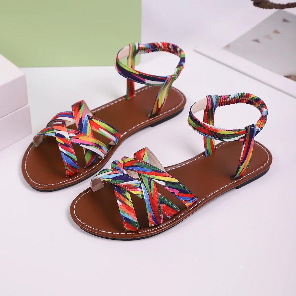 Women's handwoven criss-cross strap sandals, pair view on white background